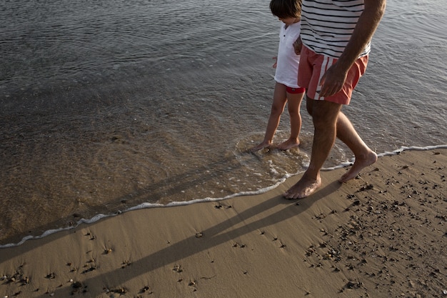 Man and child walking at the beach together