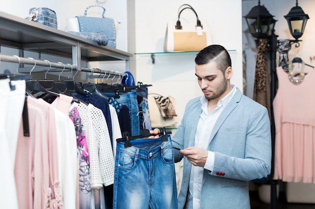 man choosing new female garment