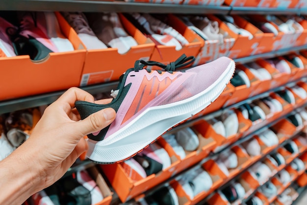 Man choosing sport shoes at fitness store