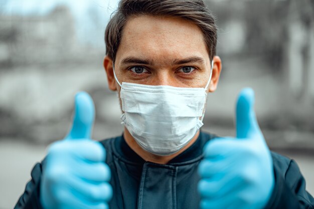 Man in city street wearing face mask protective for spreading of Coronavirus, close up