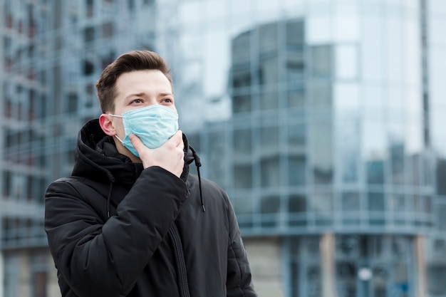 Man in the city wearing medical mask and jacket