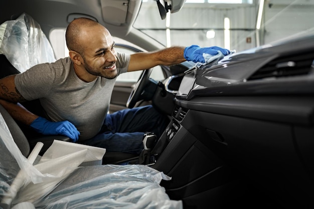 A man cleaning car interior car detailing in carwash service