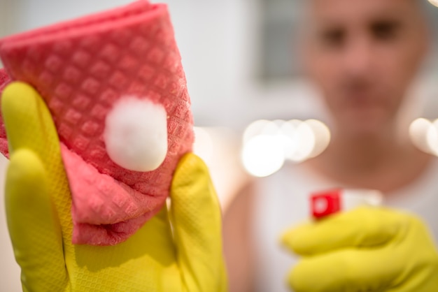 Man cleaning kitchen with spray and rag