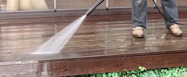 Man cleaning walls and floor with high pressure