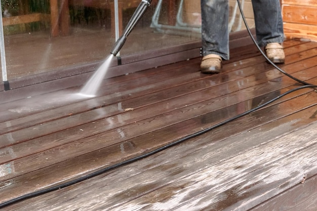 Man cleaning walls and floor with high pressure