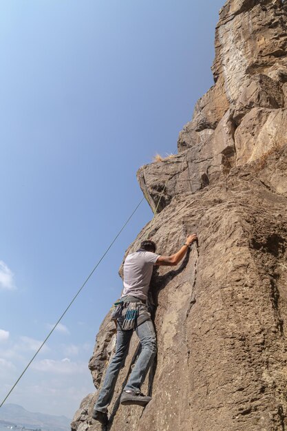 Man climbing on an impressive rock