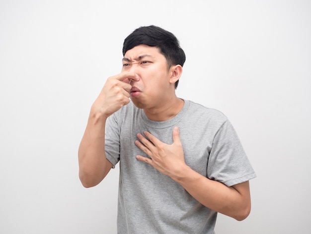 Man close his nose feeling vomit white background