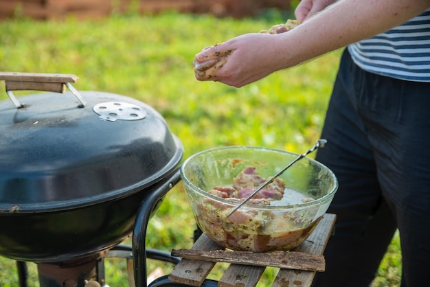 Man cocking meat in fire at back yard