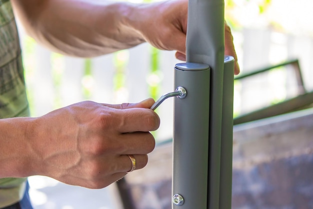 Man collects garden furniture closeup