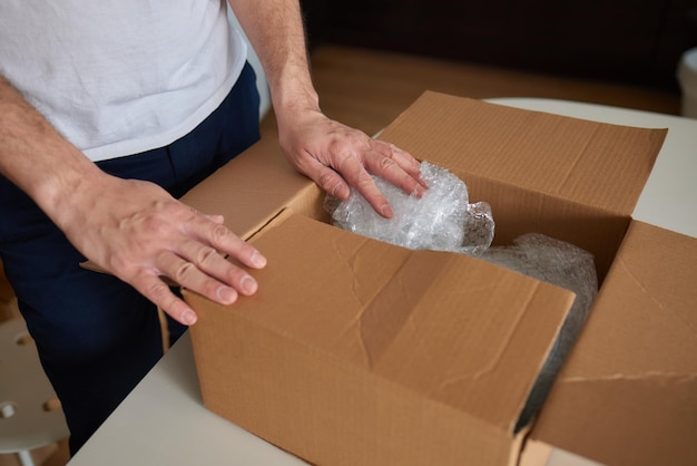 A man collects plates in boxes for moving