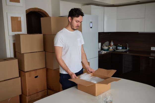 A man collects plates in boxes for moving