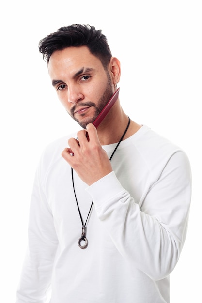 Man combing his beard on white background