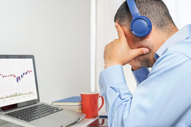 Man concerned about the decline in the value of his shares on the stock market checks charts