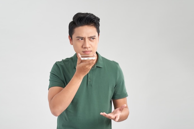 man confused aggressive in bad mood guy talking in the loudspeaker of his smartphone