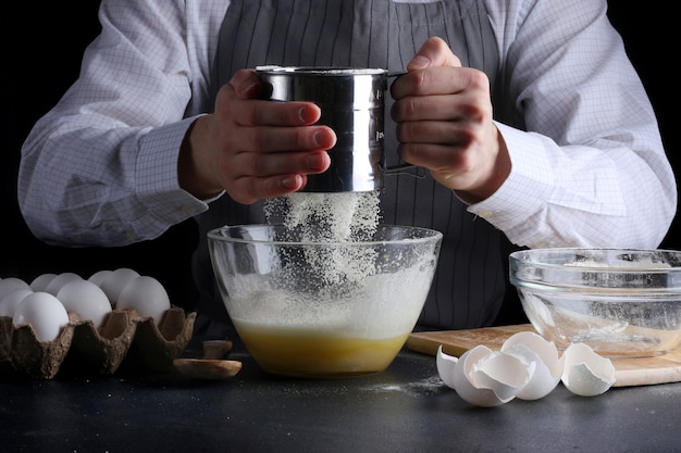 man cooking pie and Sifting flour in bowl