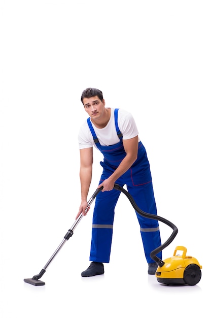 Man in coveralls doing vacuum cleaning on white