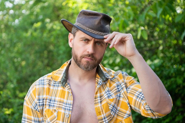 Man in cowboy hat sexy man wear checkered shirt western man wearing hat