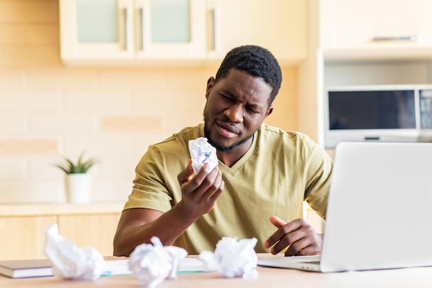 Man crushed paper while working and have no idea remote work in kitchen