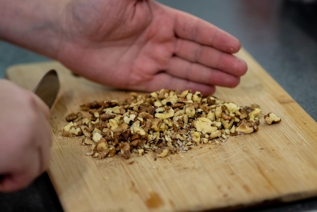 Man cuts walnuts for a pie Cooking at home