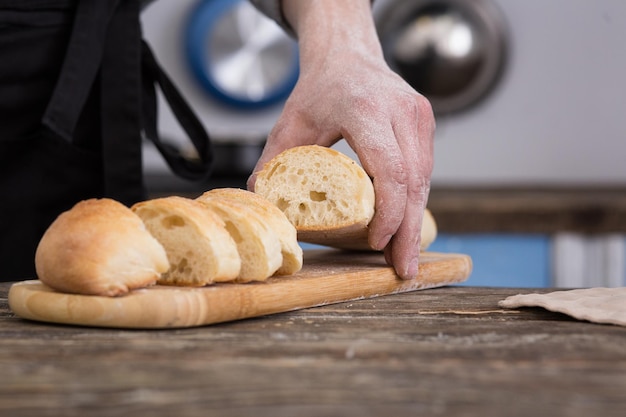 Man cutting bread on kitchen