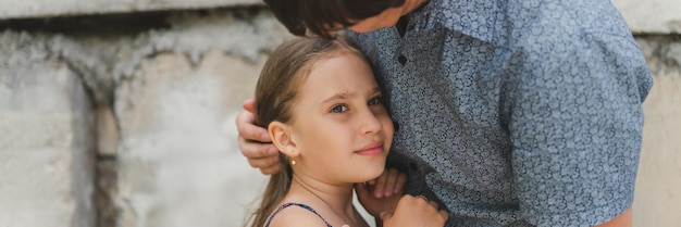 Man dad having time with kid daughter girl nine year hugs and straighten her hair happy father playing with child real life authentic daytoday fatherhood moments fatherly love care banner