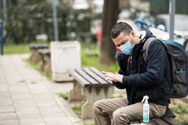 Man disinfecting his hands due to coronavirus risk