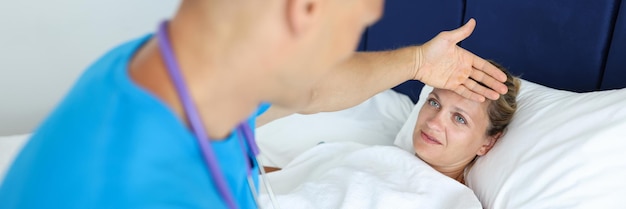 Man doctor is providing medical assistance to woman patient in lying bed home health care