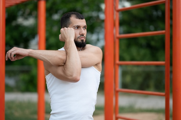 A man does a warm-up before training on the street. Workout, training, lifestyle