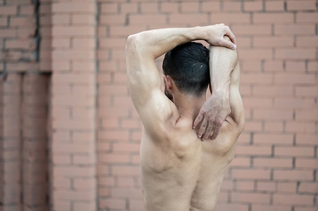 A man does a warm-up before training on the street. Workout, training, lifestyle