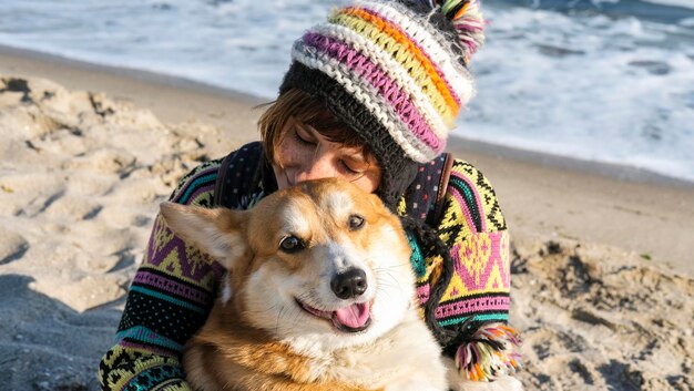 Photo a man and a dog are hugging each other and one is wearing a hat