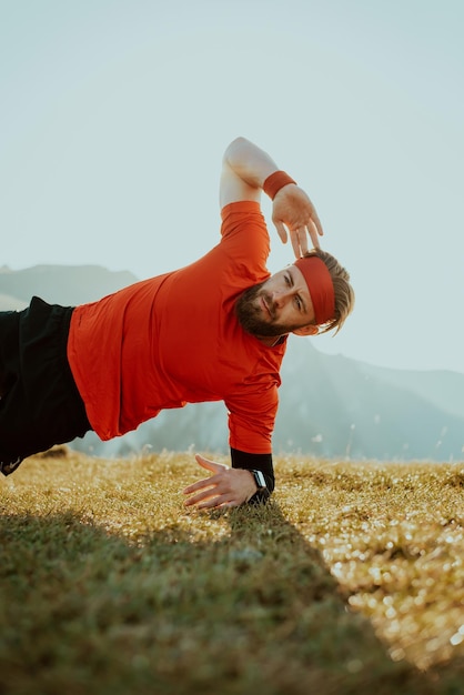 A man doing abs exercises on top of a mountain.