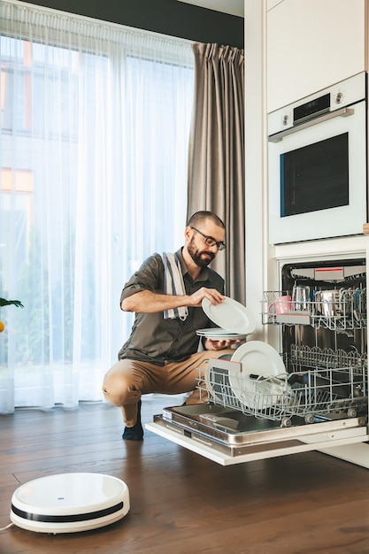 The man doing chores in the kitchen