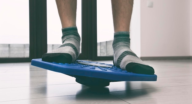 Man doing exercises on balance board