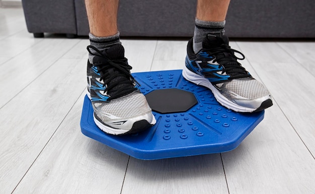 Man doing exercises on balance board