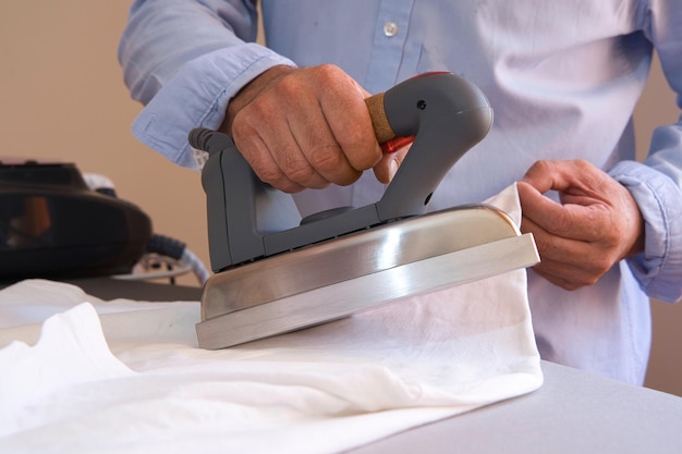 Man doing housework with the iron