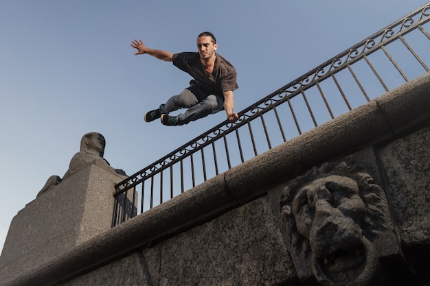 Man doing parkour in city. Athlete practicing freerunning.