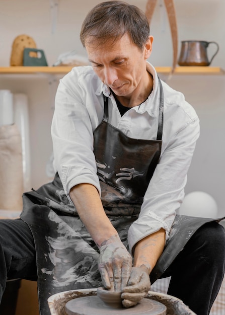 Man doing pottery medium shot