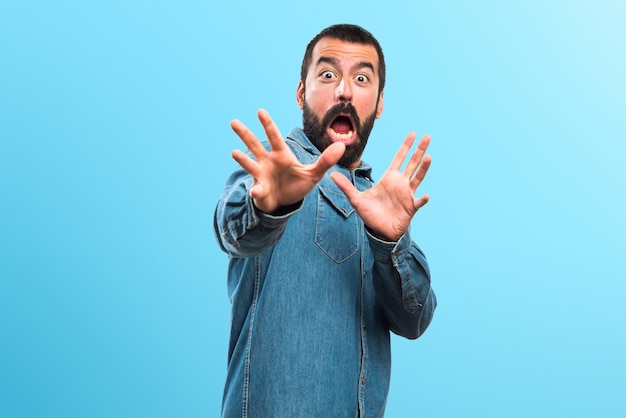 Man doing surprise gesture on colorful background