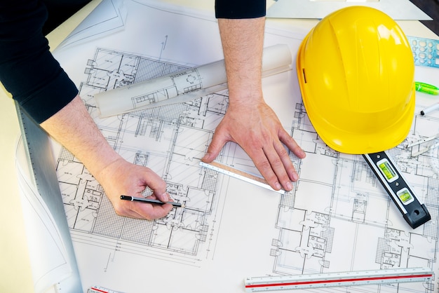 A man drawing the project of a house