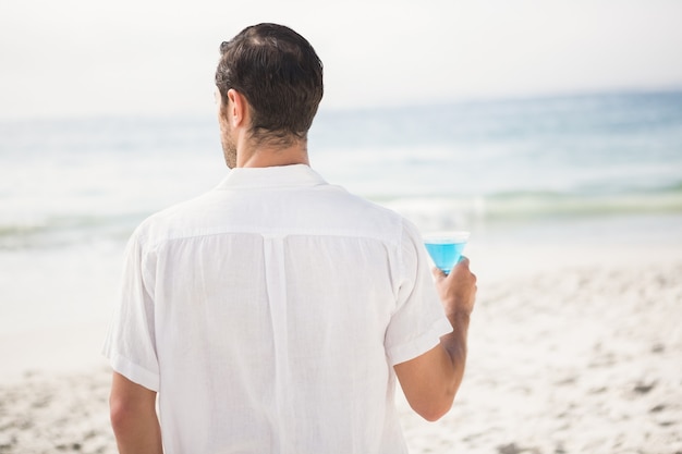 Man drinking cocktail on the beach