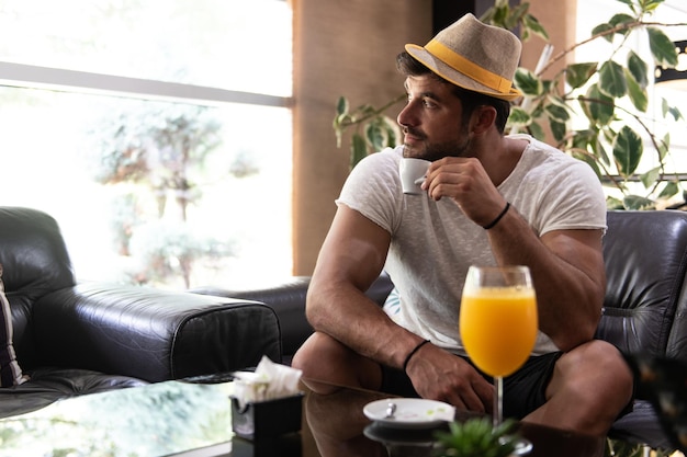 Man Drinking Coffee in a Hotel Lobby Bar