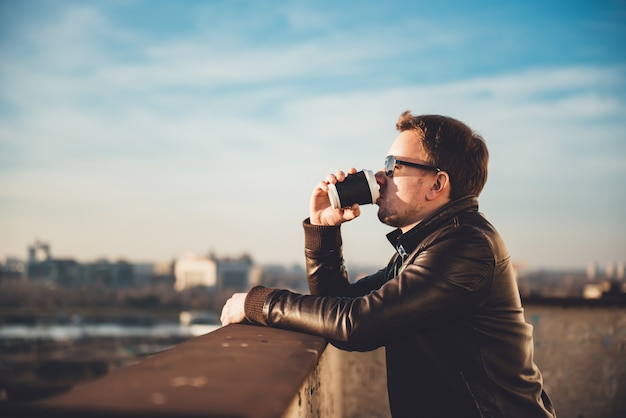 Man drinking coffee on the rooftop