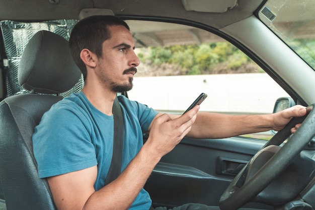 Man driving car while talking in the phone Driving and texting smart phone Danger distraction