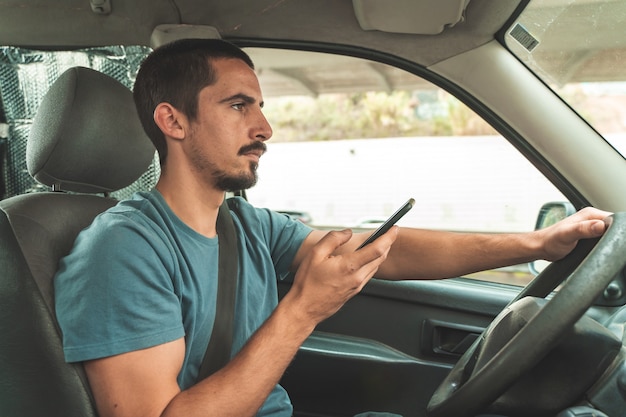 Man driving car while talking in the phone Driving and texting smart phone Danger distraction