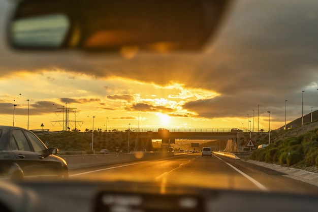 Man driving car with view from inside.