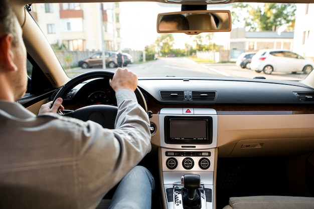 The man driving the modern car 