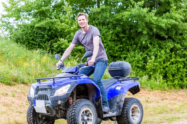 Man driving off-road with quad bike or ATV