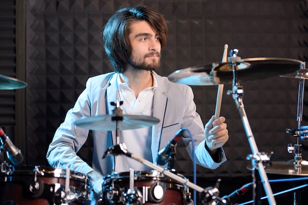 Man behind drum-type installation in a recording studio.