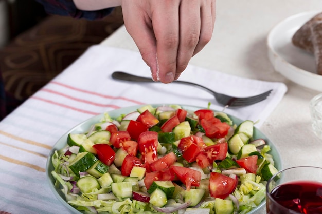 Man eating fresh vegetable salad closeup