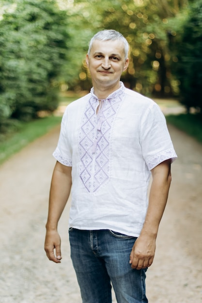 Man in embroidered linen ethnic shirt at nature